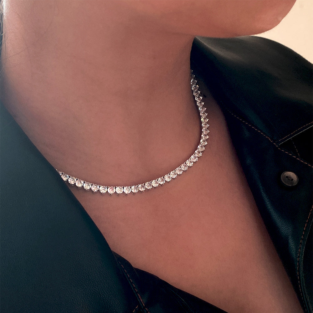 silver tennis necklace for women 3 prong setting looks like heart shape.