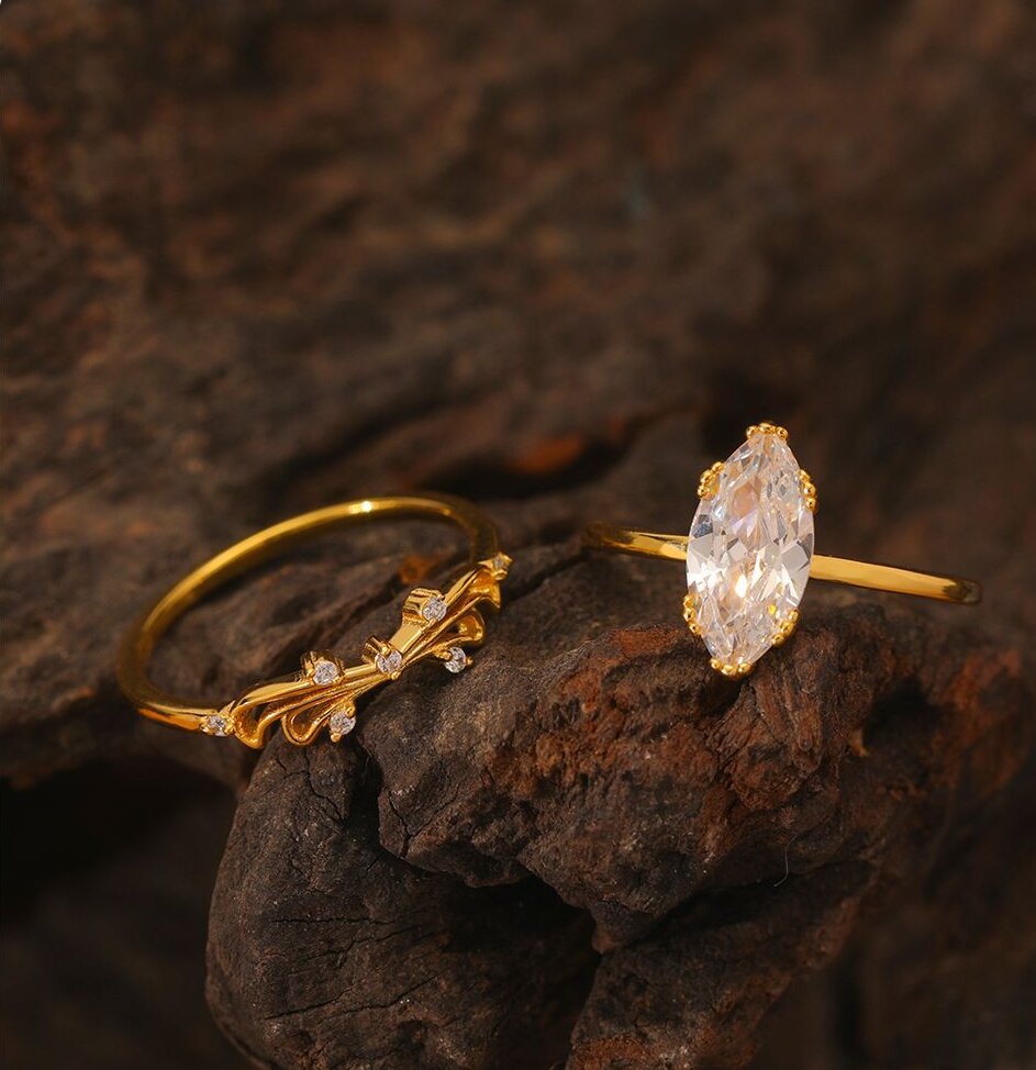 Gold-plated moissanite ring set with marquise solitaire and vine-inspired accent ring